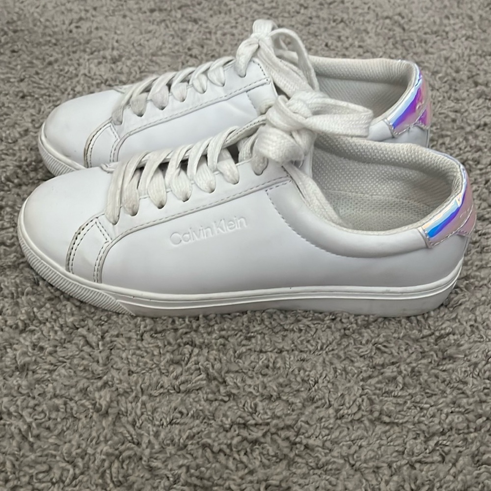 White Calvin Klein shoes with metallic detail on back